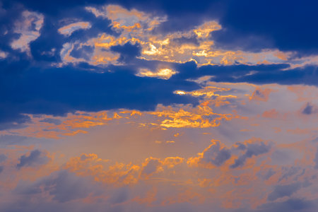 the image of sunset clouds in the evening blue and gold sky