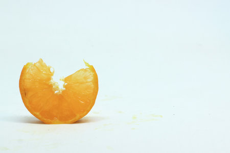 photo of orange slice with white blurred backgroundの写真素材