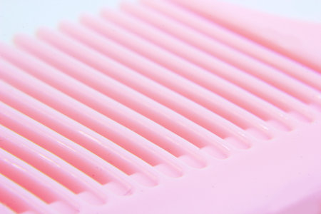 photo of a pink comb that is usually at home as a tool for smoothing hairの写真素材