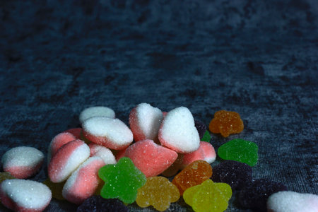 colorful candy with a variety of flavors in the photo with a cement-patterned background, the color of bright candy and fresh flavors arouse children's tastes,の写真素材