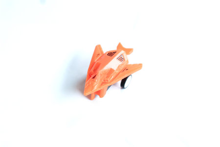 a plastic vehicle toy with a white isolated background, commonly used as a tool to introduce types...