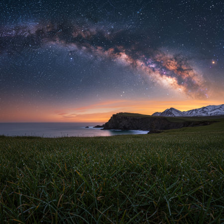 Milky Way over the sea with grass and mountains in the backgroundの素材