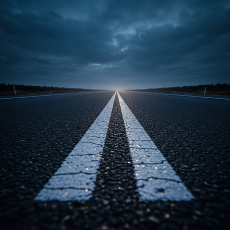 Asphalt road at sunset with the sun in the sky. Abstract backgroundの素材