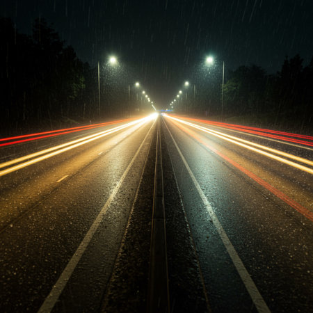 Car lights in the rain on the road. Long exposure photo.の素材
