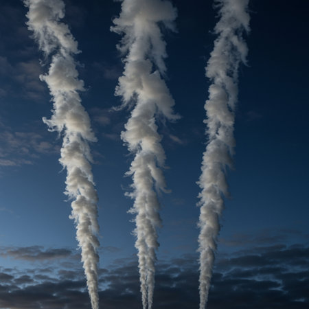 A group of white smoke clouds on a dark blue sky background.の素材