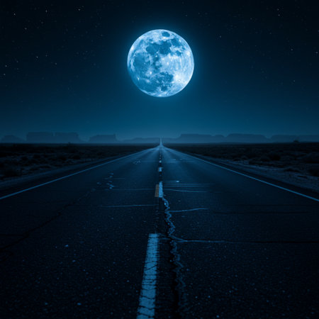 road in the desert at night with a full moon in the skyの素材