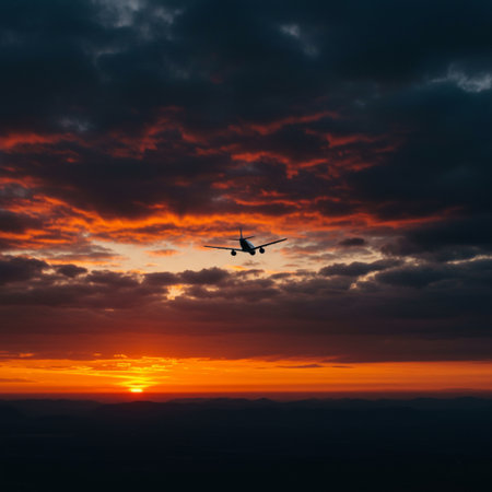 Silhouette of airplane flying above the clouds at sunset. Travel conceptの素材