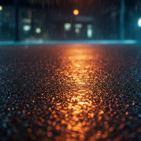 Rain drops on the asphalt road at night. Shallow depth of field.の素材
