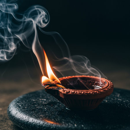Burning diya with smoke on dark background. Diwali conceptの素材