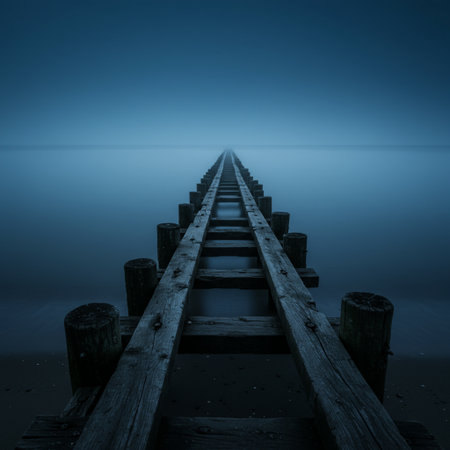 Old wooden pier on a foggy morning. Long exposure photo.の素材