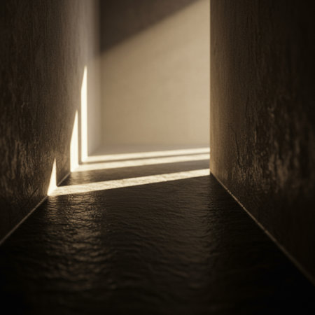Light coming through the end of a corridor in a dark room.の素材
