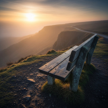 Sunrise on the top of the mountain with a bench in the foregroundの素材