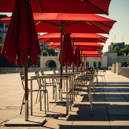 Outdoor restaurant with red umbrellas and chairs in Paris, Franceの素材