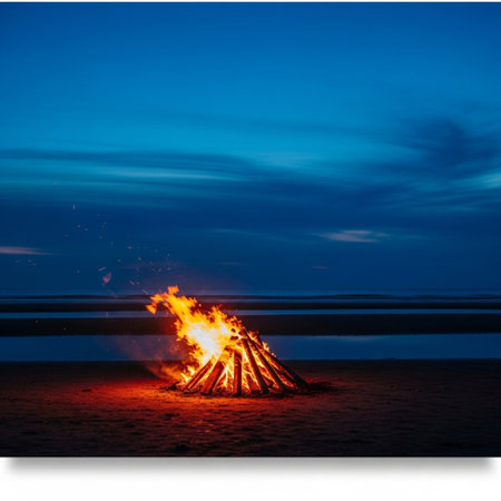 Bonfire on the beach in the evening with blue sky background.の素材