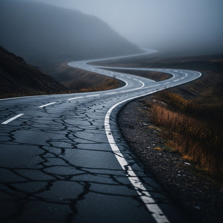 Winding road on the mountain in foggy day, Iceland.の素材