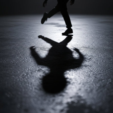 Silhouette of a man skating on ice in a dark roomの素材
