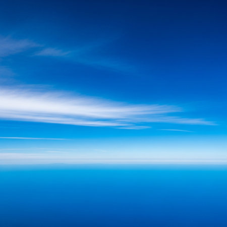 Blue sky and clouds as seen through window of an aircraft. Abstract backgroundの素材