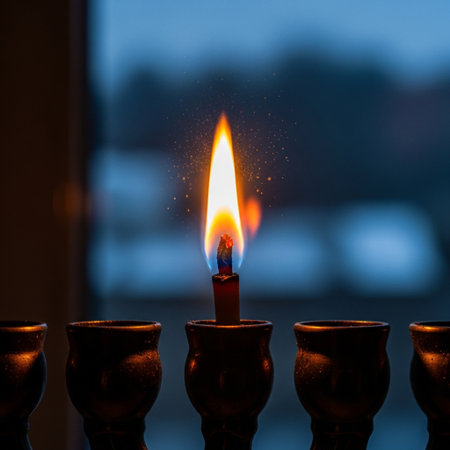 Burning candle in a candlestick on a dark background.の素材