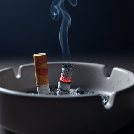 Cigarette butt in ashtray with smoke on dark backgroundの素材