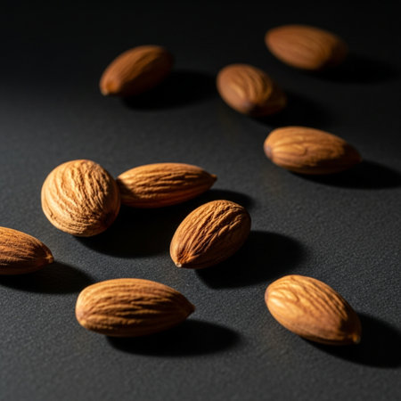 Almond nuts on black background. Shallow depth of field.の素材