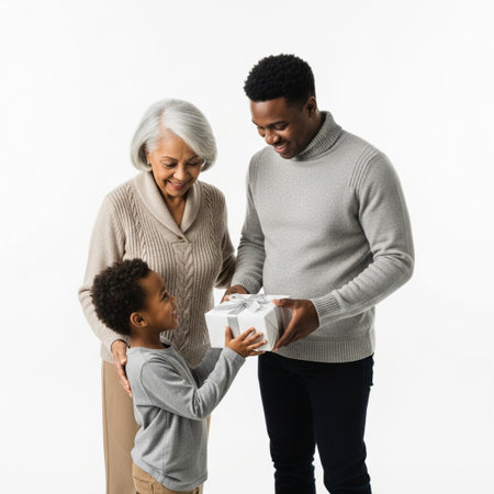 happy african american family with little boy holding gift box isolated on whiteの素材