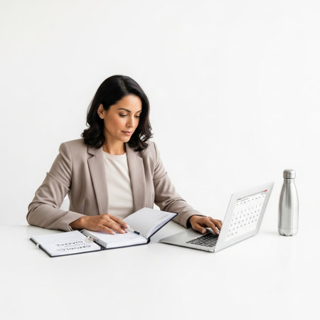 attractive businesswoman working with laptop and notebook, isolated on whiteの素材