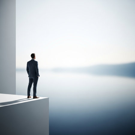 businessman standing on the edge of the wall and looking at the lakeの素材