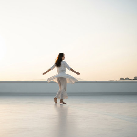 Ballet dancer in white dress dancing on white terrace at sunset.の素材