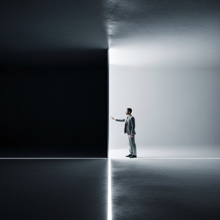 Businessman standing in dark room with light coming from the open doorの素材