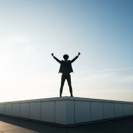 Silhouette of a man standing on the roof of a buildingの素材
