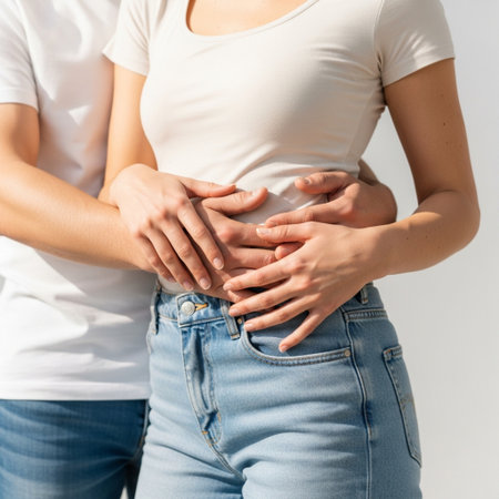 Cropped image of pregnant woman and her husband holding hands on bellyの素材