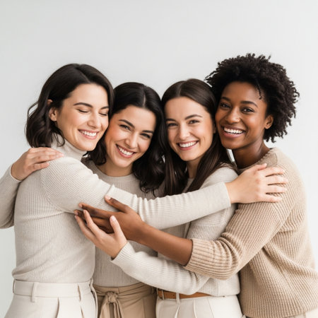happy multiethnic women hugging and looking at camera isolated on greyの素材