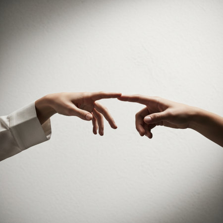 Two female hands touching each other on a white wall background. Close-upの素材
