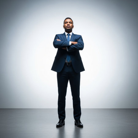 Handsome african american business man standing with crossed arms on grey backgroundの素材