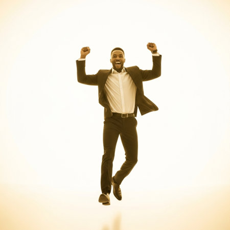Full length portrait of a happy businessman celebrating success isolated over white backgroundの素材