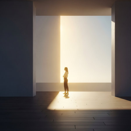 Young woman standing in empty room with sunlight coming through the window.の素材