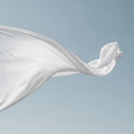 abstract piece of white fabric flying high in the blue sky, image use for backgroundの素材