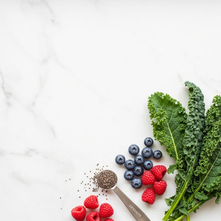 Healthy food background. Top view of fresh green kale, raspberries, blueberries and chia seeds on white marble table.の素材