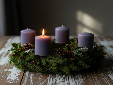 Christmas wreath with burning candles on a wooden background, selective focusの素材
