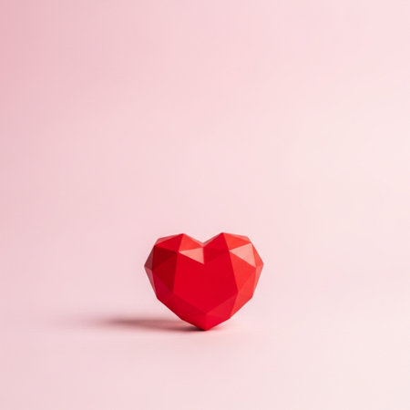 Red polygonal heart on a pink background. Love concept.の素材