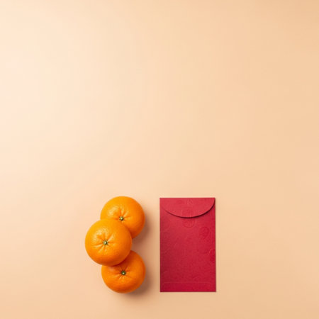 Top view of red envelope and oranges on beige background with copy spaceの素材