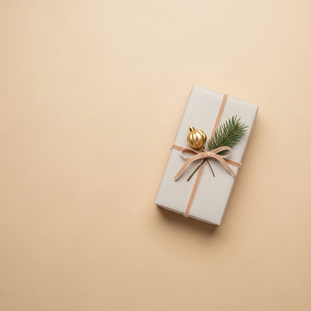 Christmas or New Year composition. Gifts, pine branches, golden ball on beige background. Flat lay, top view, copy spaceの素材