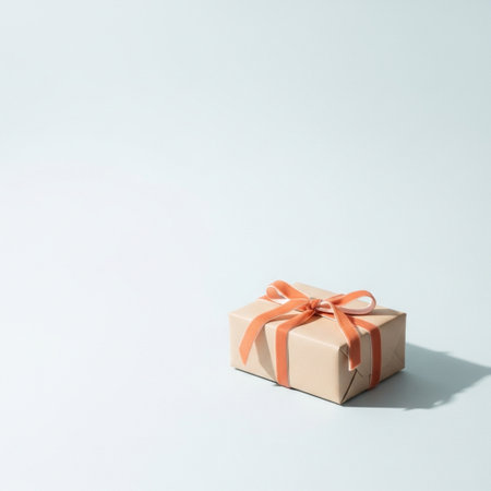 Gift box with orange ribbon on white background. Copy space.の素材