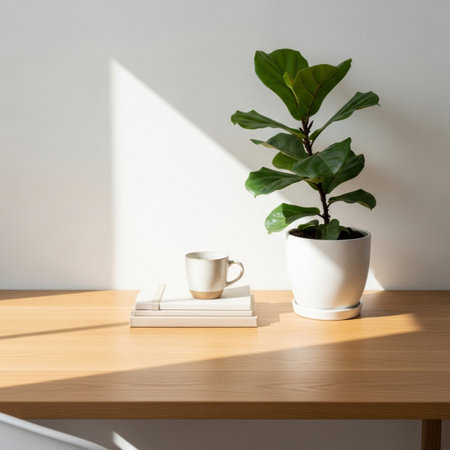 Coffee cup with ficus plant on wooden table and white wallの素材