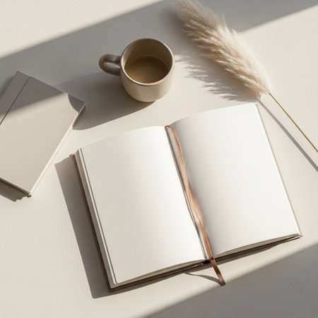 Blank notebook, coffee cup and pampas grass on white backgroundの素材