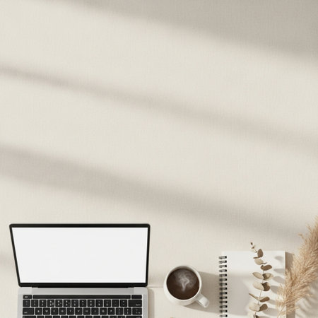 Minimalistic workspace with laptop, coffee cup, notebook and plant on white wall background. Flat lay, top viewの素材