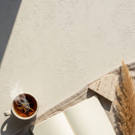 Cup of coffee, notebook and pampas grass on white backgroundの素材