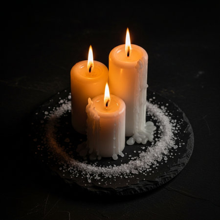 Candles with sea salt on a black background. Selective focus.の素材