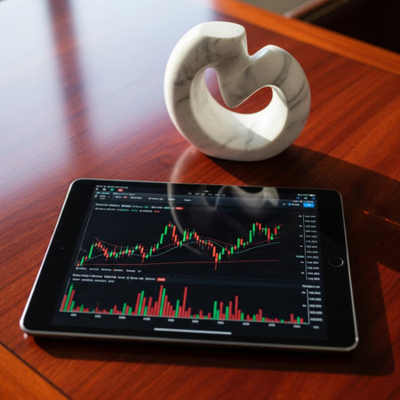 tablet with stock market chart on screen and coffee cup on tableの素材