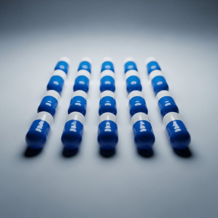 A row of blue and white pills on a grey background with copy spaceの素材